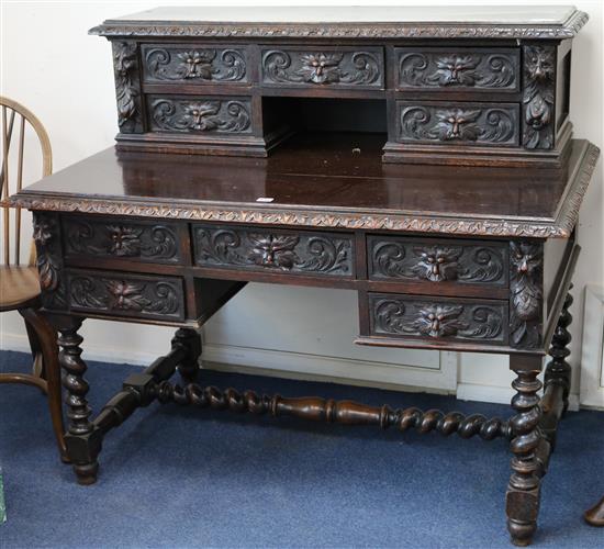 A late Victorian carved oak writing desk W.122cm